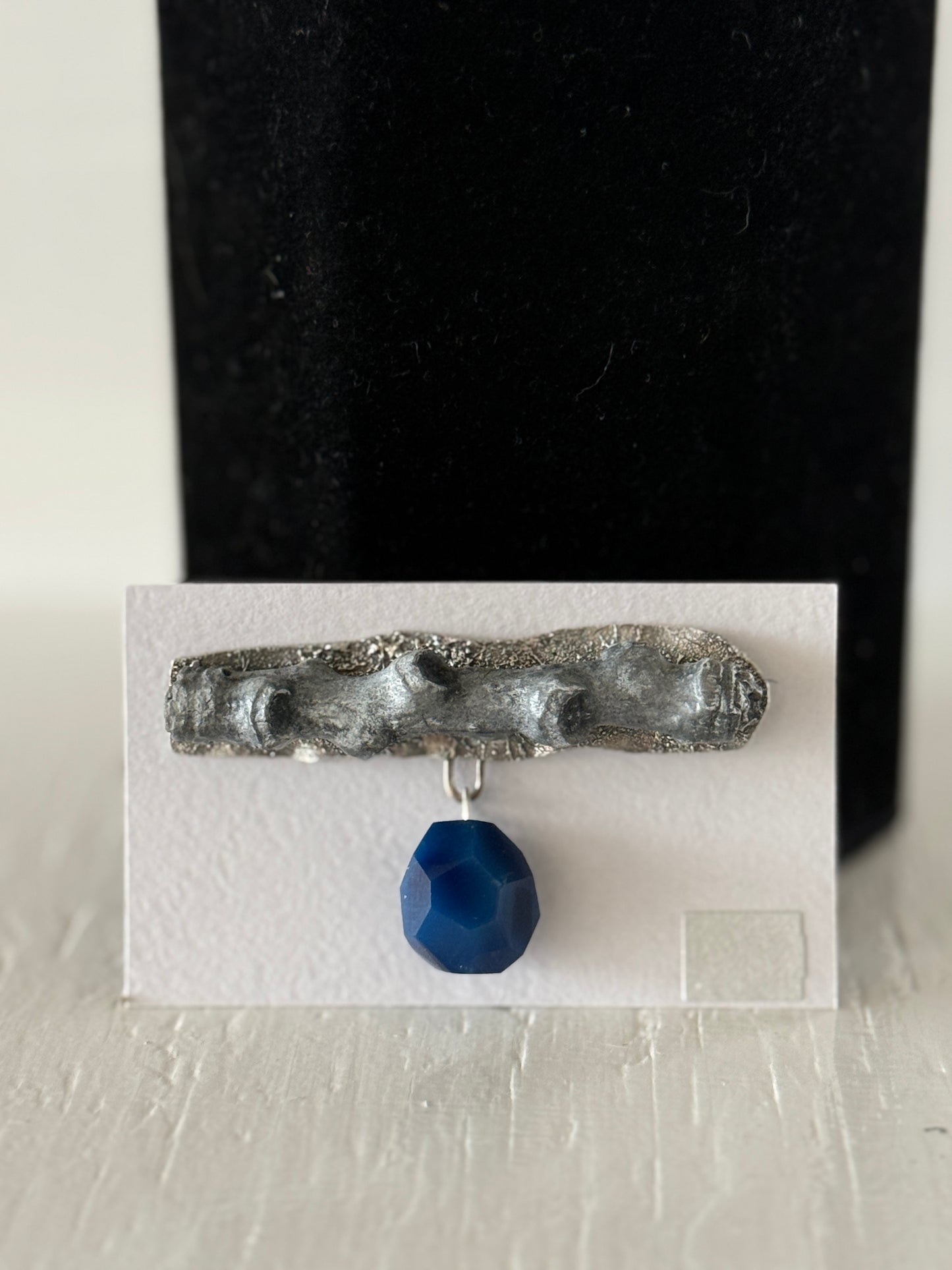 Leigh Roberts: Gesso & Graphite powder cottonwood stem brooch on fused sterling with blue agate