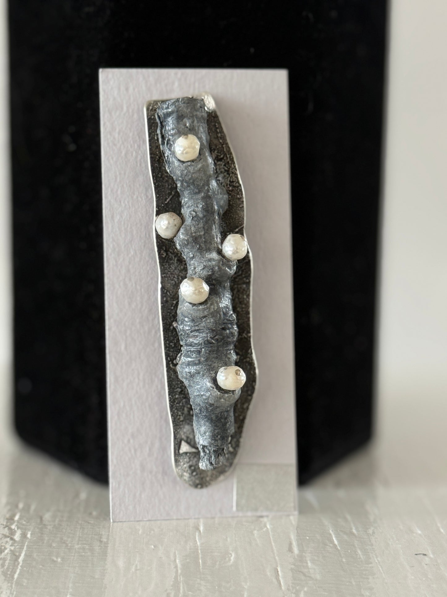 Leigh Roberts: Gesso & Graphite powder cottonwood stem brooch on fused sterling with pearls